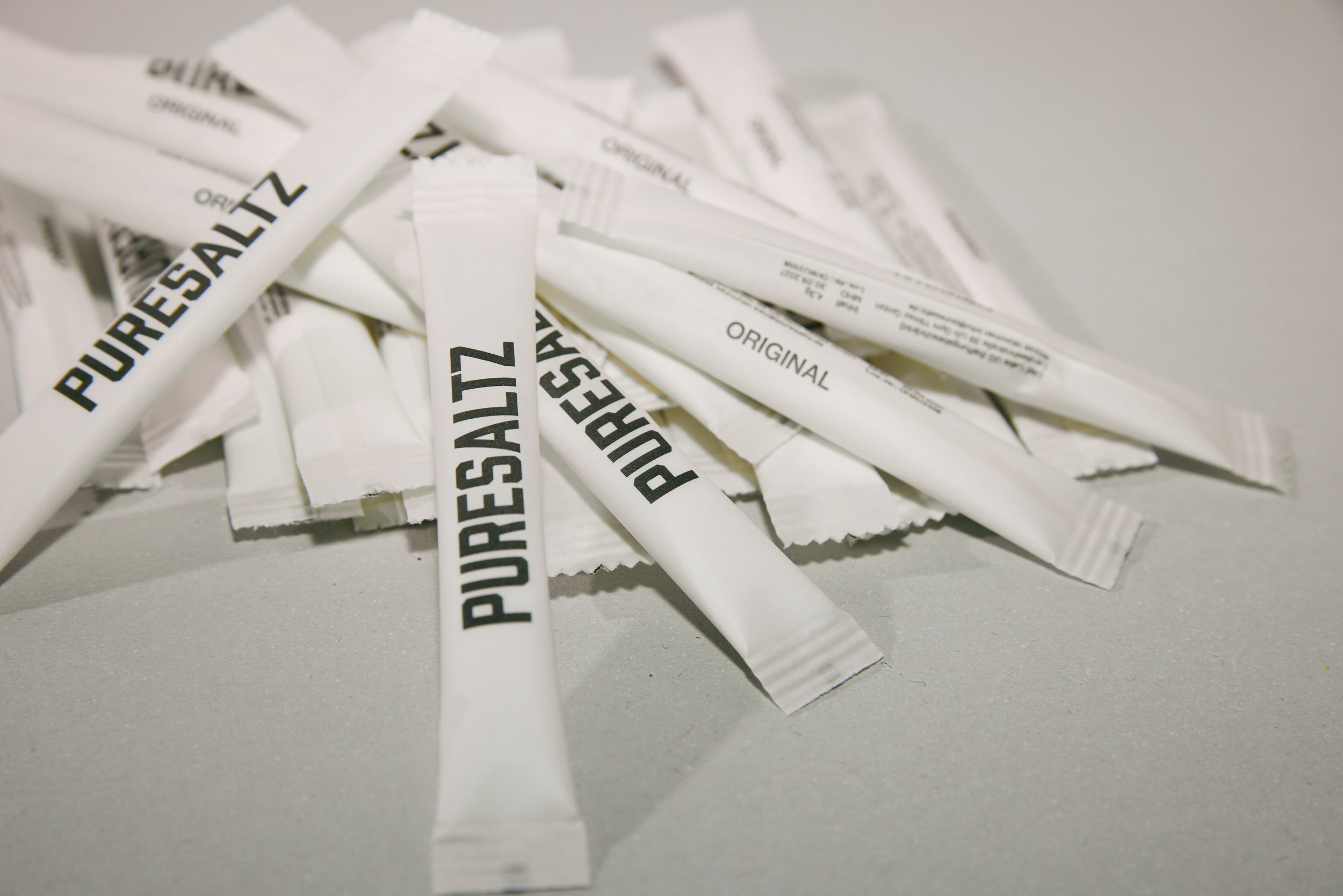 Multiple Pure Saltz packets on a light gray background